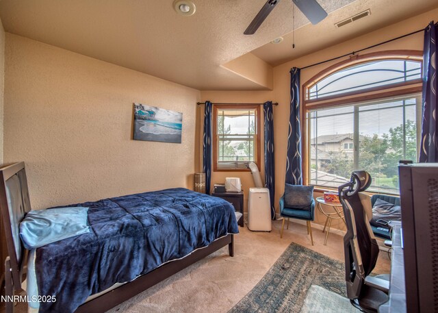 6752 Eagle Wing Cir, Sparks, NV 89436 - bedroom featuring carpet, a textured wall, and a ceiling fan