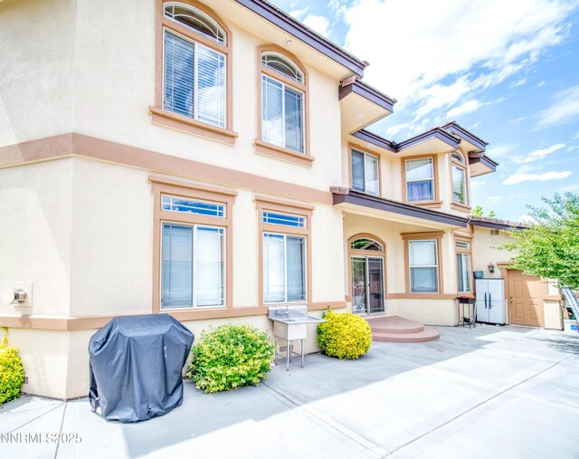 6752 Eagle Wing Cir, Sparks, NV 89436 - back of house with stucco siding and a patio area