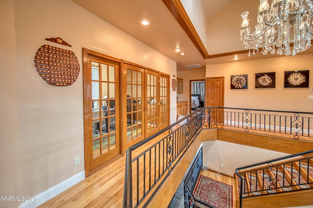 6752 Eagle Wing Cir, Sparks, NV 89436 - stairway featuring a chandelier, wood finished floors, recessed lighting, a high ceiling, and french doors