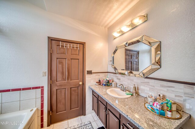 6752 Eagle Wing Cir, Sparks, NV 89436 - full bathroom featuring tile walls, vanity, a bathtub, tile patterned flooring, and wainscoting