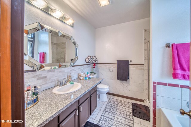 6752 Eagle Wing Cir, Sparks, NV 89436 - bathroom featuring tile walls, tile patterned floors, vanity, a shower, and a garden tub