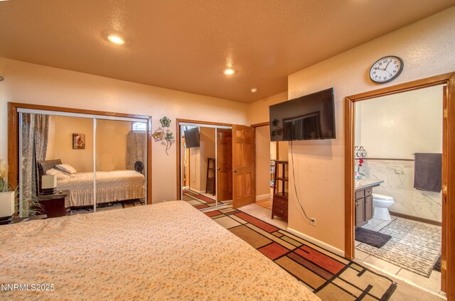 6752 Eagle Wing Cir, Sparks, NV 89436 - bedroom featuring two closets, connected bathroom, and recessed lighting