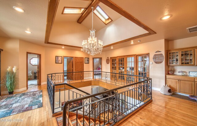 6752 Eagle Wing Cir, Sparks, NV 89436 - corridor featuring an upstairs landing, a chandelier, wood finished floors, and recessed lighting