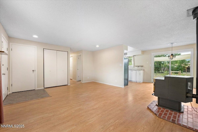 3830 Avocet Ct, Reno, NV 89508 - unfurnished living room featuring a textured ceiling, light wood finished floors, and recessed lighting