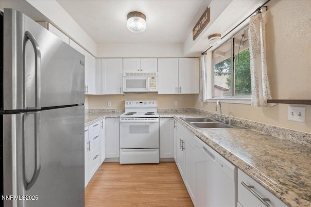 3830 Avocet Ct, Reno, NV 89508 - kitchen featuring white appliances, white cabinets, light countertops, and light wood finished floors
