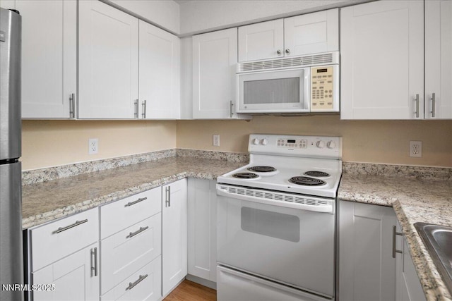 3830 Avocet Ct, Reno, NV 89508 - kitchen with white appliances, white cabinetry, and light stone counters
