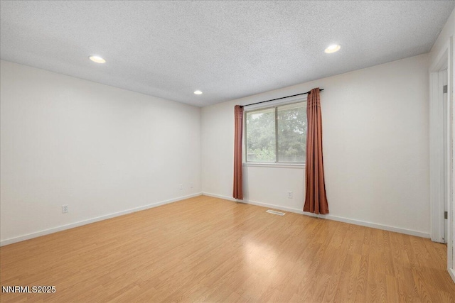 3830 Avocet Ct, Reno, NV 89508 - spare room featuring light wood finished floors, a textured ceiling, and recessed lighting