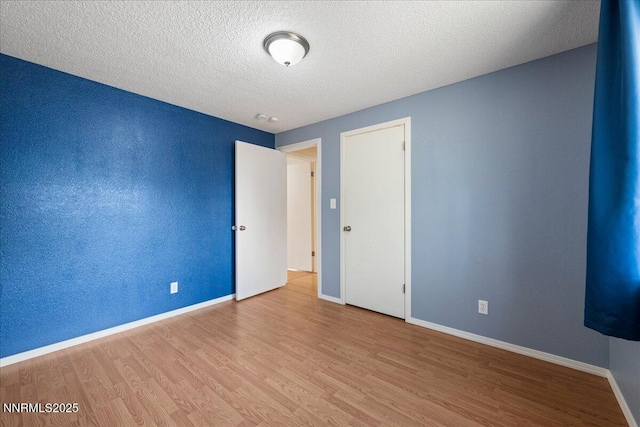 3830 Avocet Ct, Reno, NV 89508 - unfurnished bedroom featuring wood finished floors and a textured ceiling