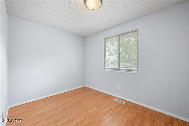 3830 Avocet Ct, Reno, NV 89508 - empty room with wood finished floors and a textured ceiling