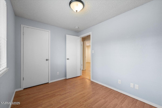 3830 Avocet Ct, Reno, NV 89508 - unfurnished bedroom with light wood-type flooring and a textured ceiling