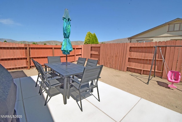 17711 Casita Ct, Reno, NV 89508 - fenced backyard featuring a patio, outdoor dining area, and a mountain view