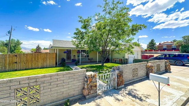 241 W National Ave, Winnemucca, NV 89445 - view of front facade with a gate, a porch, a fenced front yard, and a garage