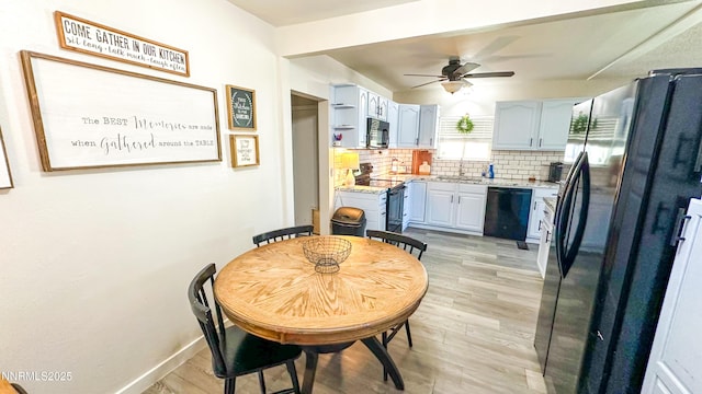 241 W National Ave, Winnemucca, NV 89445 - kitchen with dishwasher, stainless steel electric stove, freestanding refrigerator, ceiling fan, and backsplash
