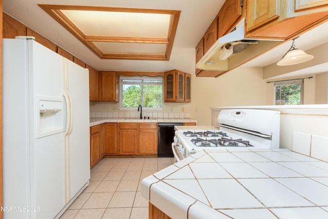 804 Bluerock Rd, Gardnerville, NV 89460 - kitchen with white appliances, tile counters, light tile patterned flooring, glass insert cabinets, and under cabinet range hood