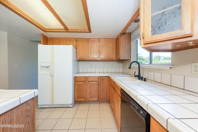 804 Bluerock Rd, Gardnerville, NV 89460 - kitchen featuring white refrigerator with ice dispenser, black dishwasher, tile counters, and glass insert cabinets