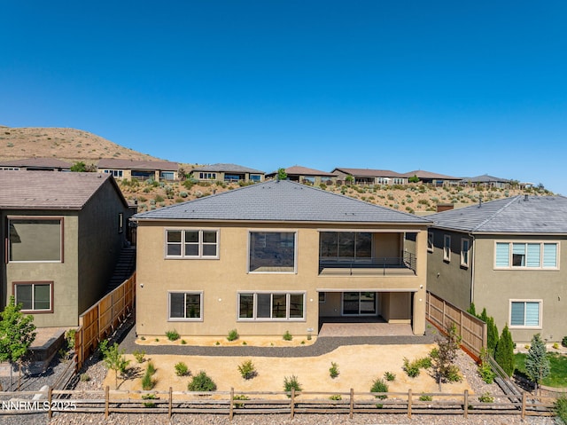 2241 Cold Creek Trl, Reno, NV 89523 - view of front of home featuring a balcony, a fenced backyard, a patio, and stucco siding