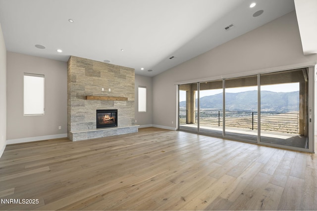 2241 Cold Creek Trl, Reno, NV 89523 - unfurnished living room with a mountain view, light wood finished floors, high vaulted ceiling, a fireplace, and recessed lighting