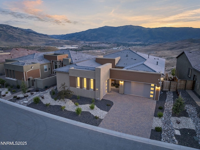 2241 Cold Creek Trl, Reno, NV 89523 - modern home with an attached garage, stucco siding, a mountain view, a gate, and driveway