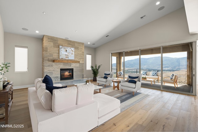 2241 Cold Creek Trl, Reno, NV 89523 - living area featuring a mountain view, light wood finished floors, a large fireplace, recessed lighting, and high vaulted ceiling