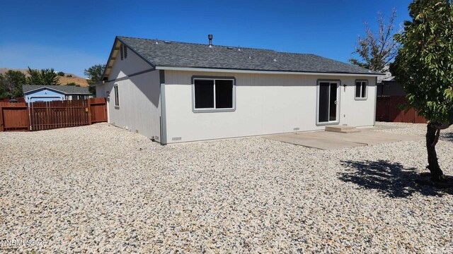 5910 Poinsettia Ct, Sun Valley, NV 89433 - back of property featuring a patio area and a shingled roof