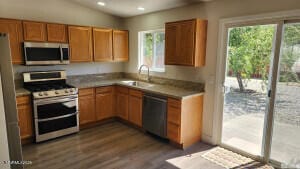 5910 Poinsettia Ct, Sun Valley, NV 89433 - kitchen featuring stainless steel appliances, dark wood-style flooring, a sink, brown cabinetry, and recessed lighting