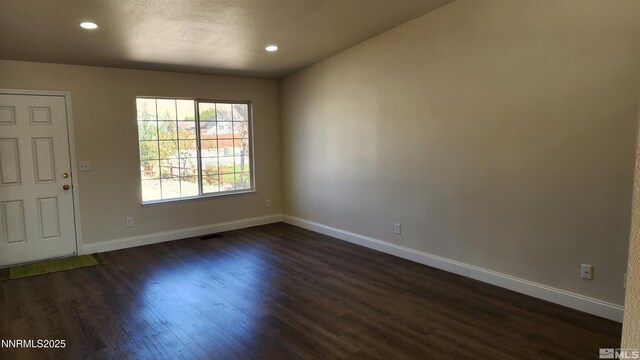 5910 Poinsettia Ct, Sun Valley, NV 89433 - empty room featuring dark wood-style flooring, baseboards, and recessed lighting