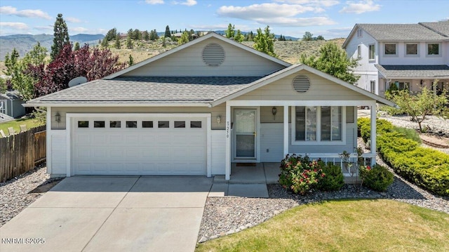 7250 Timber Ridge Ct, Reno, NV 89523 - view of front of house with roof with shingles, a porch, a garage, concrete driveway, and a mountain view
