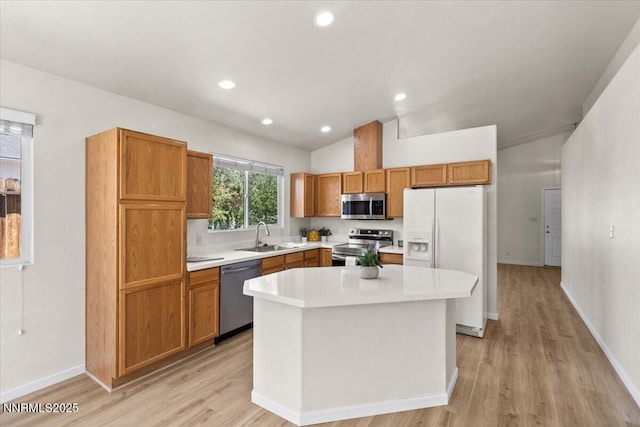 7250 Timber Ridge Ct, Reno, NV 89523 - kitchen with stainless steel appliances, lofted ceiling, light countertops, light wood-type flooring, and a kitchen island