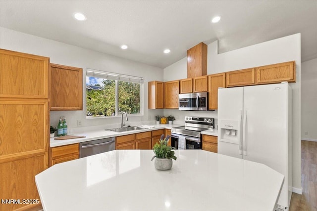 7250 Timber Ridge Ct, Reno, NV 89523 - kitchen with appliances with stainless steel finishes, light countertops, recessed lighting, a center island, and brown cabinetry