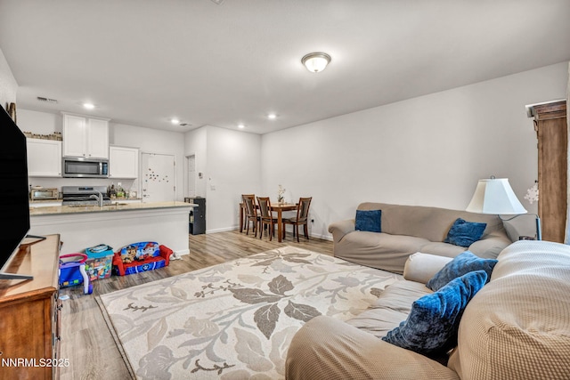 529 Autumn Breeze Cir, Reno, NV 89511 - living room featuring light wood-style flooring, recessed lighting, and baseboards