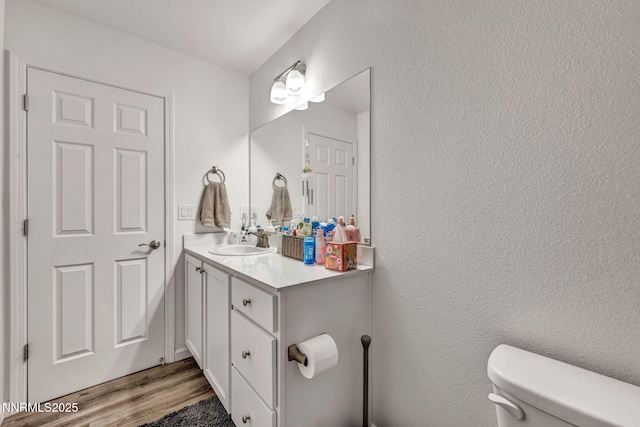 529 Autumn Breeze Cir, Reno, NV 89511 - bathroom featuring toilet, vanity, wood finished floors, and a textured wall