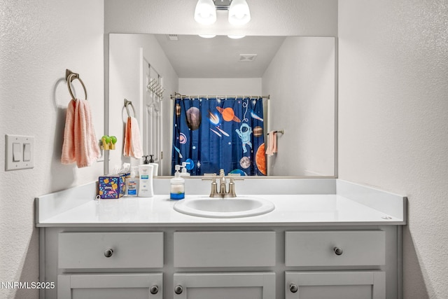 529 Autumn Breeze Cir, Reno, NV 89511 - bathroom with vanity, a textured wall, and a shower with curtain