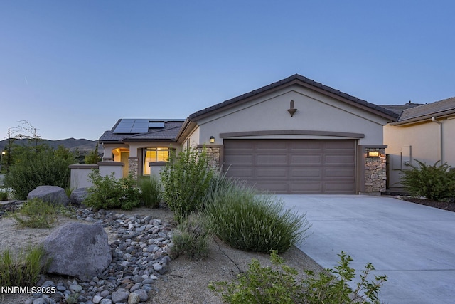 9195 Summertree Ct, Reno, NV 89523 - view of front facade featuring stucco siding, stone siding, and driveway