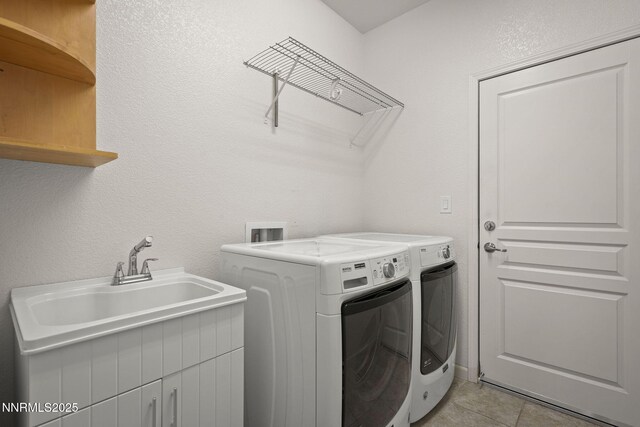 9195 Summertree Ct, Reno, NV 89523 - washroom featuring washer and clothes dryer and light tile patterned floors
