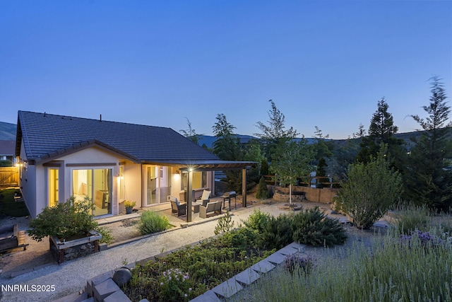 9195 Summertree Ct, Reno, NV 89523 - rear view of house featuring a patio area, a tile roof, stucco siding, a pergola, and an outdoor hangout area
