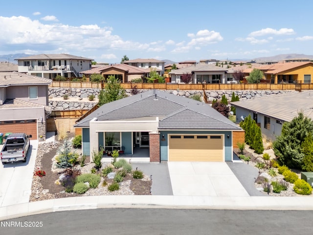 4697 High Pass Ct, Sparks, NV 89436 - view of front of house featuring a residential view, a porch, concrete driveway, a tiled roof, and an attached garage