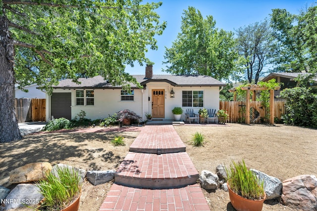 705 Elm St, Carson City, NV 89703 - ranch-style home featuring stucco siding, a garage, and a chimney