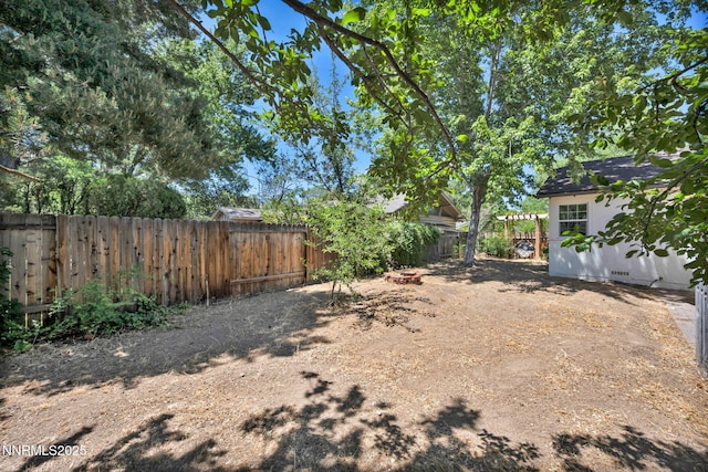 705 Elm St, Carson City, NV 89703 - fenced backyard featuring a fire pit