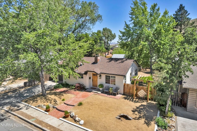 705 Elm St, Carson City, NV 89703 - view of front facade featuring a shingled roof, stucco siding, and a chimney