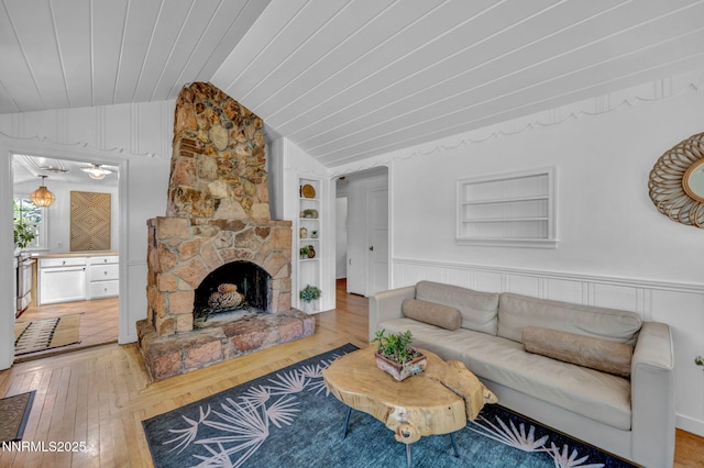 705 Elm St, Carson City, NV 89703 - living area with vaulted ceiling, built in features, light wood finished floors, wainscoting, and a fireplace