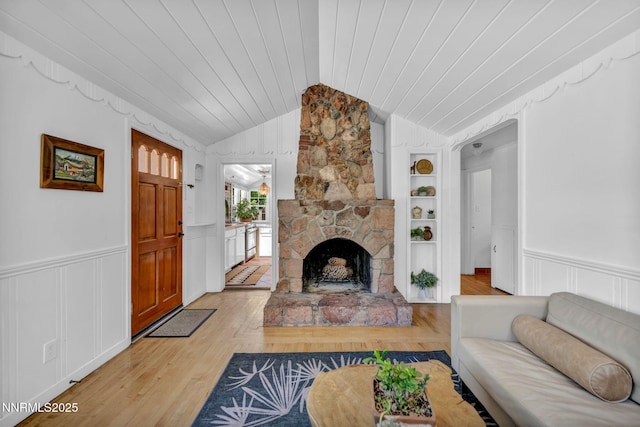 705 Elm St, Carson City, NV 89703 - living room with lofted ceiling, a decorative wall, light wood-type flooring, wooden ceiling, and a stone fireplace