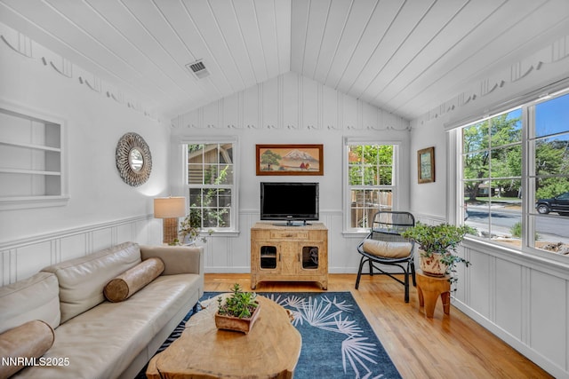 705 Elm St, Carson City, NV 89703 - living room featuring light wood-type flooring, vaulted ceiling, a wainscoted wall, a decorative wall, and wooden ceiling