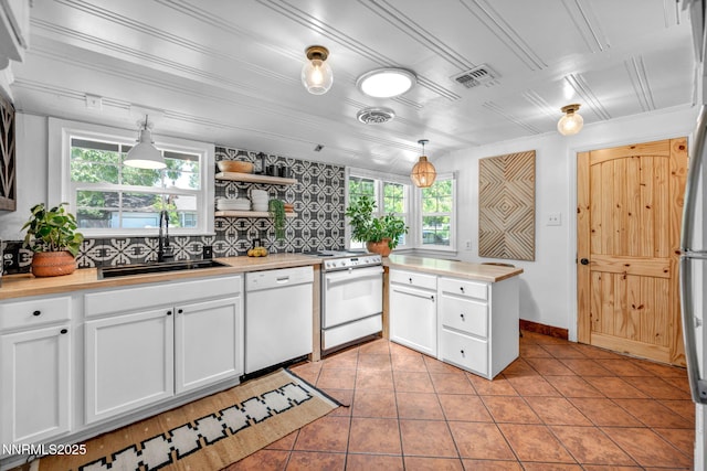 705 Elm St, Carson City, NV 89703 - kitchen featuring white appliances, light countertops, light tile patterned flooring, and white cabinets