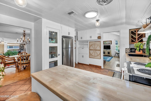 705 Elm St, Carson City, NV 89703 - kitchen with stainless steel appliances, light tile patterned flooring, and plenty of natural light