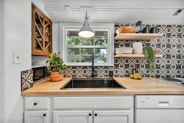 705 Elm St, Carson City, NV 89703 - kitchen with butcher block counters, dishwasher, white cabinetry, decorative backsplash, and open shelves