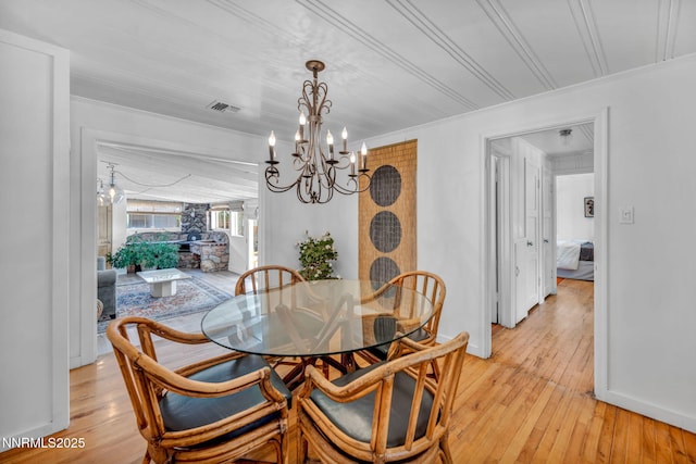 705 Elm St, Carson City, NV 89703 - dining area featuring a chandelier, light wood finished floors, and ornamental molding