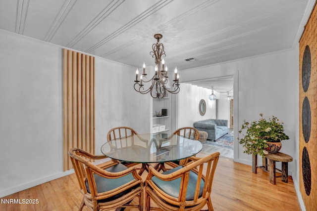 705 Elm St, Carson City, NV 89703 - dining space with a chandelier, light wood-style flooring, and ornamental molding