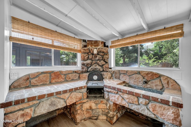 705 Elm St, Carson City, NV 89703 - detailed view of wood finished floors, beamed ceiling, and a wood stove