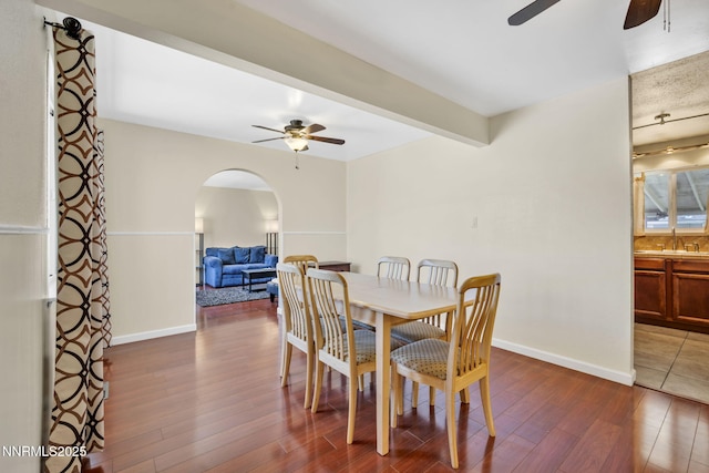 3310 Delna Dr, Sparks, NV 89431 - dining area featuring ceiling fan, arched walkways, and dark wood-style floors