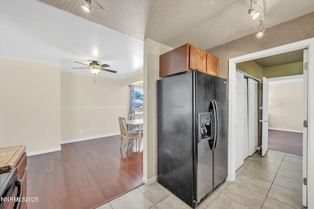 3310 Delna Dr, Sparks, NV 89431 - kitchen with black refrigerator with ice dispenser, track lighting, a ceiling fan, and stove
